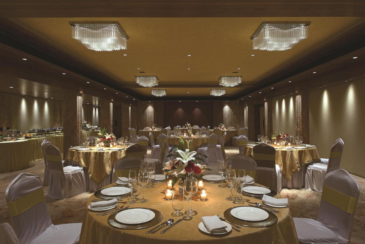 a banquet room with tables and chairs and chandeliers at Hotel Lakend in Udaipur +72 photos