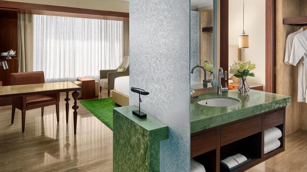 a bathroom with a sink and a room at Park Hyatt Chennai in Chennai