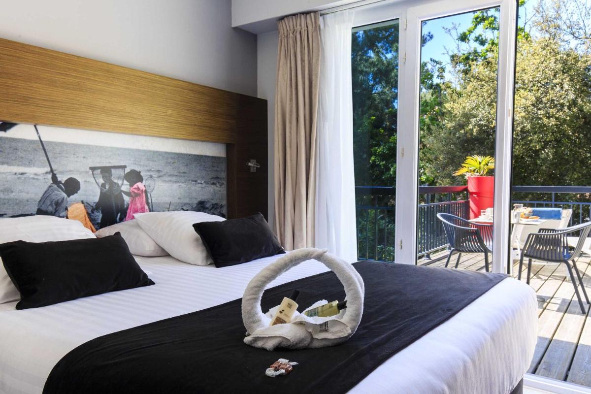 Un ou plusieurs lits dans un hébergement de l'établissement Best Western Hôtel Garden and Spa
