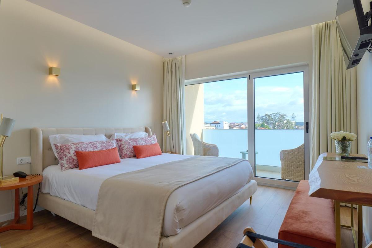 Uma cama ou camas num quarto em Hotel de Ilhavo Plaza & Spa