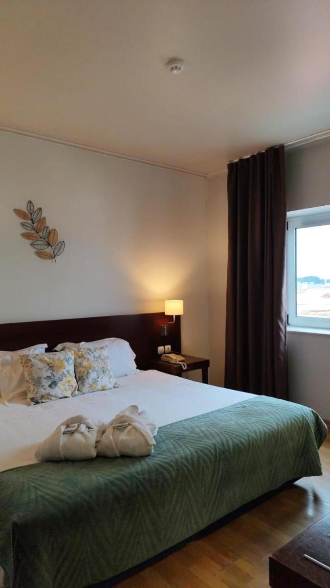 Uma cama ou camas num quarto em Hotel de Ilhavo Plaza & Spa