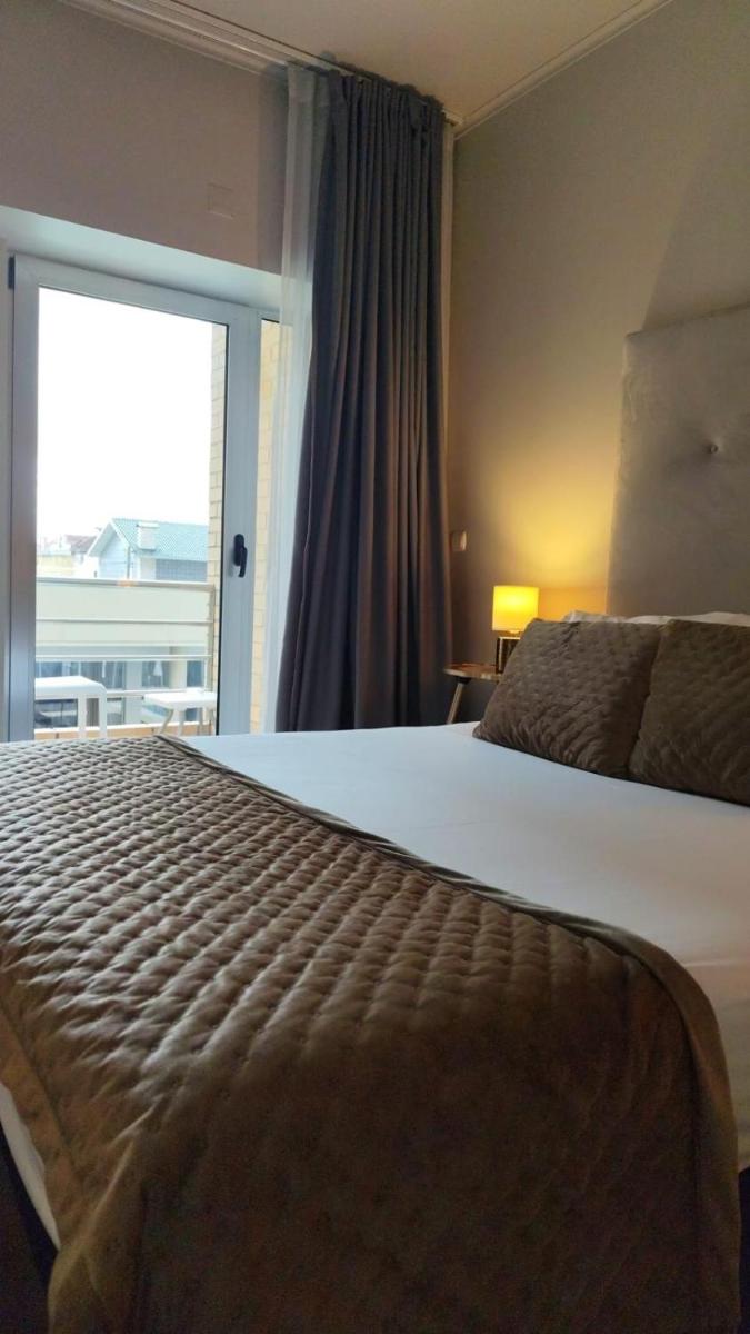 Uma cama ou camas num quarto em Hotel de Ilhavo Plaza & Spa