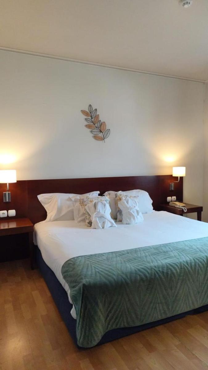 Uma cama ou camas num quarto em Hotel de Ilhavo Plaza & Spa