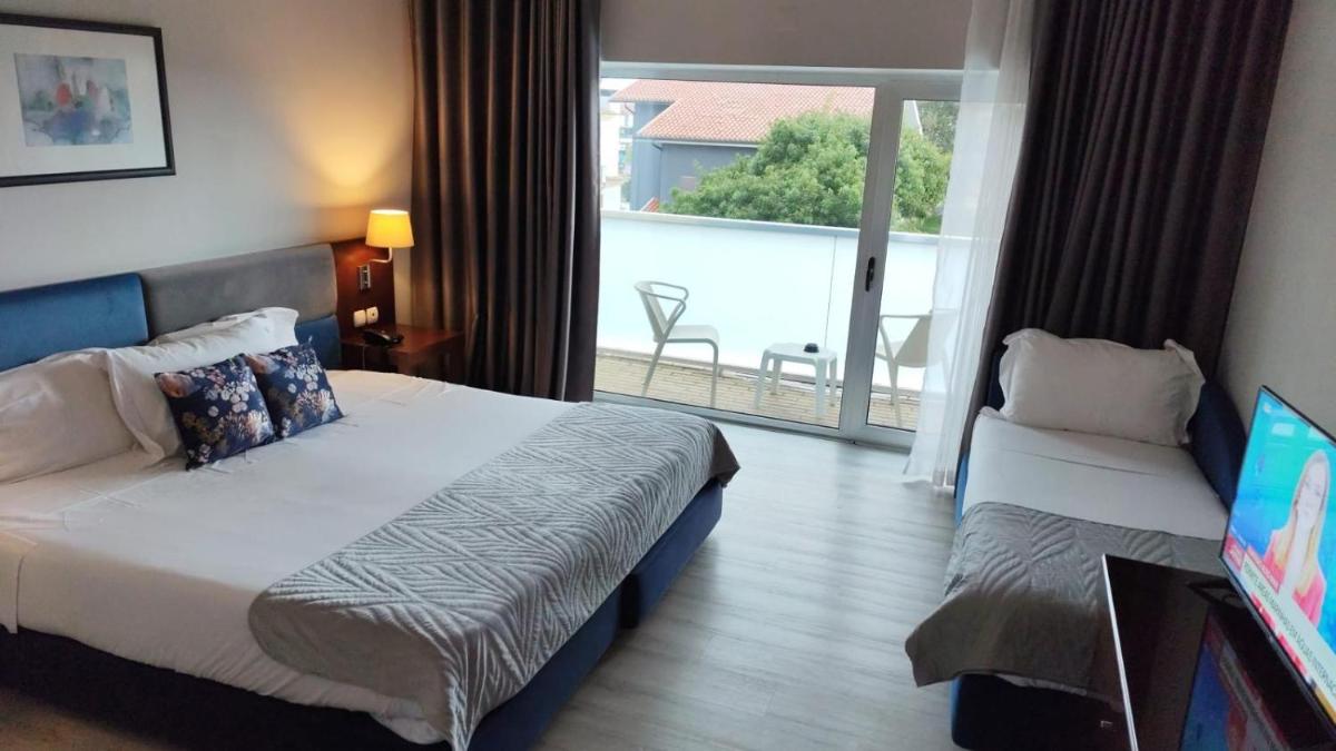 Uma cama ou camas num quarto em Hotel de Ilhavo Plaza & Spa