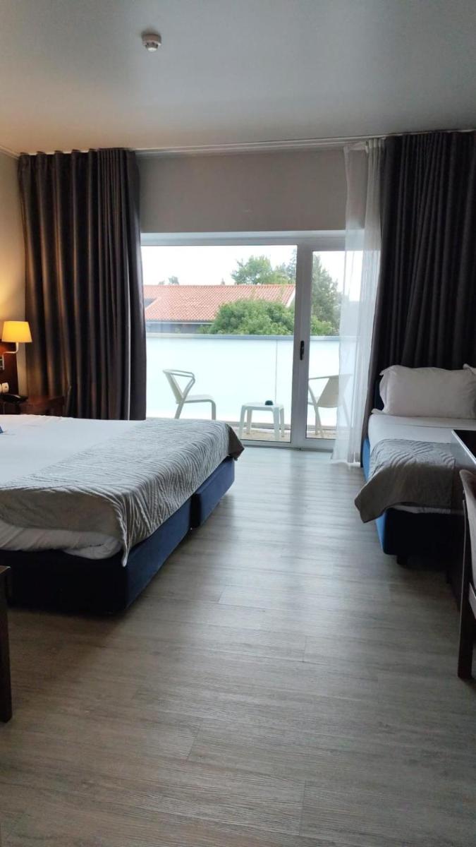 Uma cama ou camas num quarto em Hotel de Ilhavo Plaza & Spa