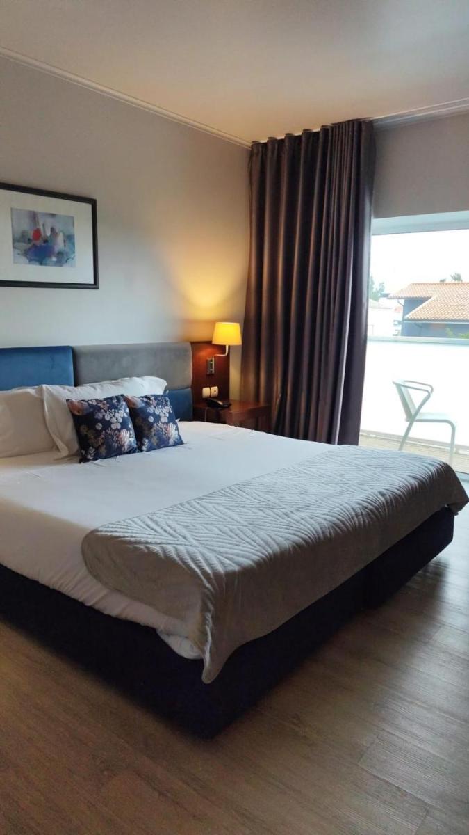 Uma cama ou camas num quarto em Hotel de Ilhavo Plaza & Spa