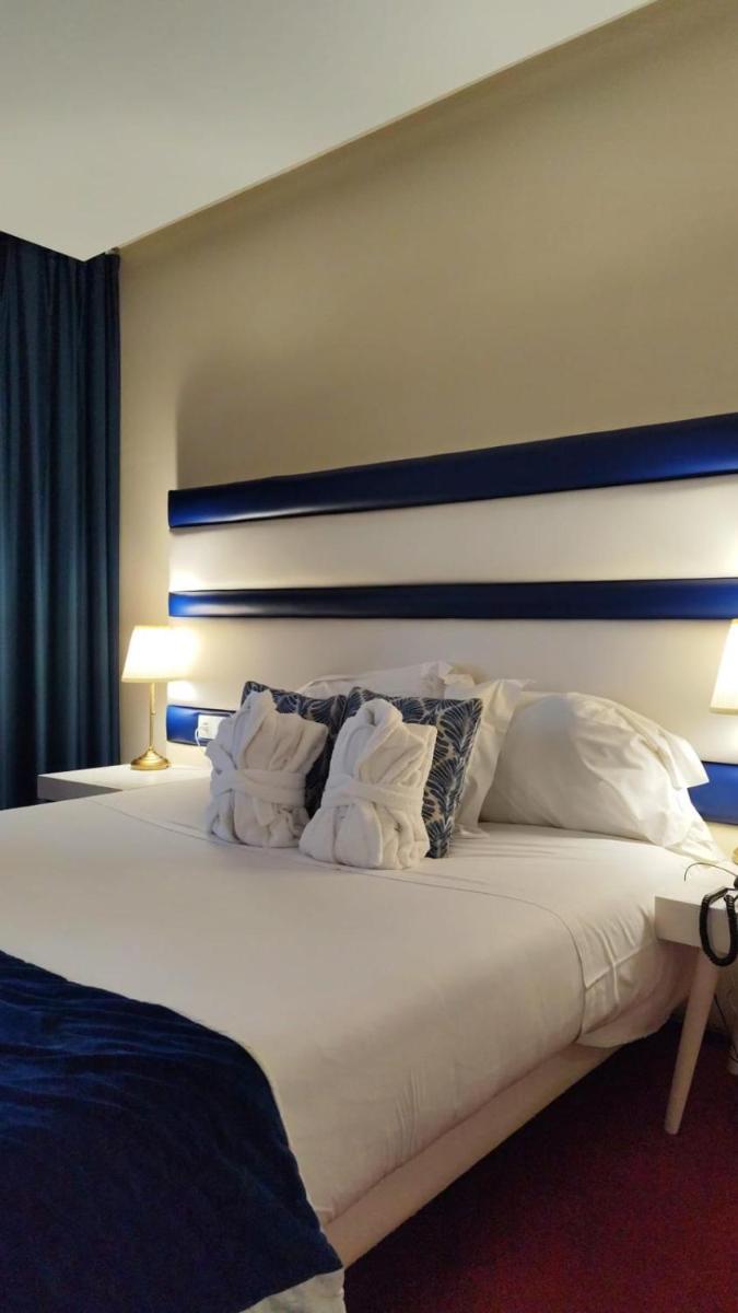 Uma cama ou camas num quarto em Hotel de Ilhavo Plaza & Spa