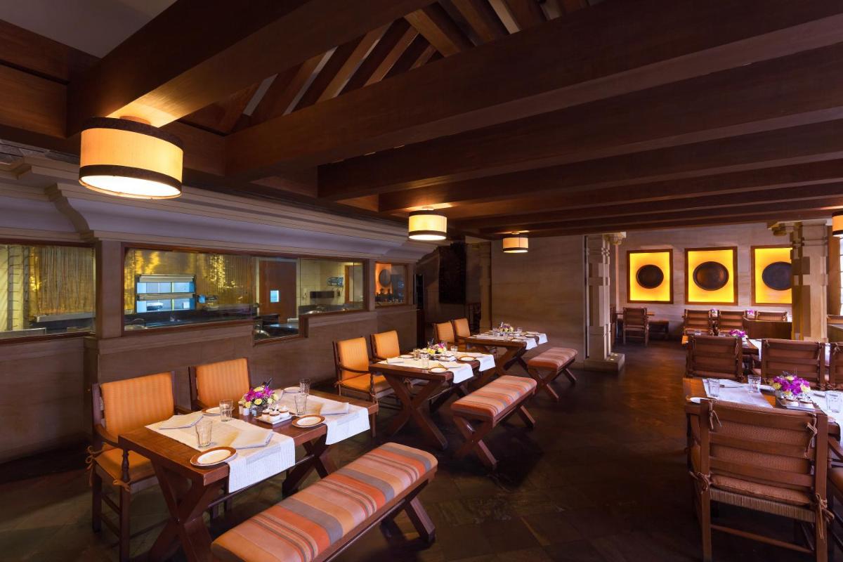 a dining room with tables and chairs in a restaurant at ITC Kakatiya, a Luxury Collection Hotel, Hyderabad in Hyderabad