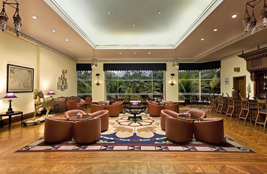 a large lobby with leather chairs and tables and windows at ITC Kakatiya, a Luxury Collection Hotel, Hyderabad in Hyderabad