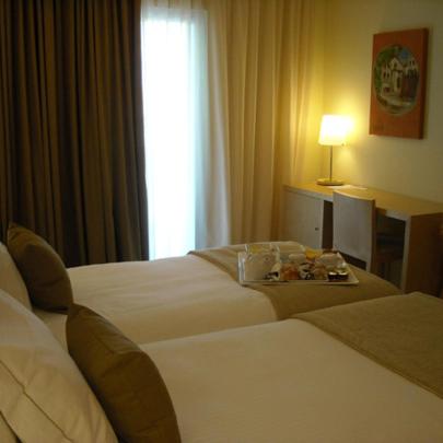 Uma cama ou camas num quarto em INLIMA Hotel & Spa