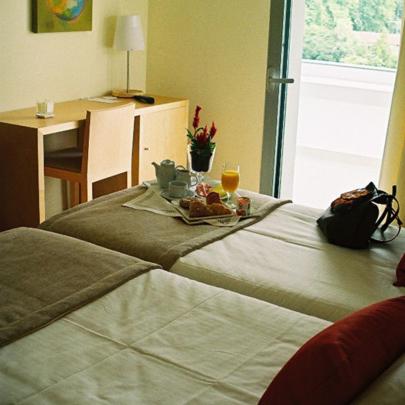 Uma cama ou camas num quarto em INLIMA Hotel & Spa