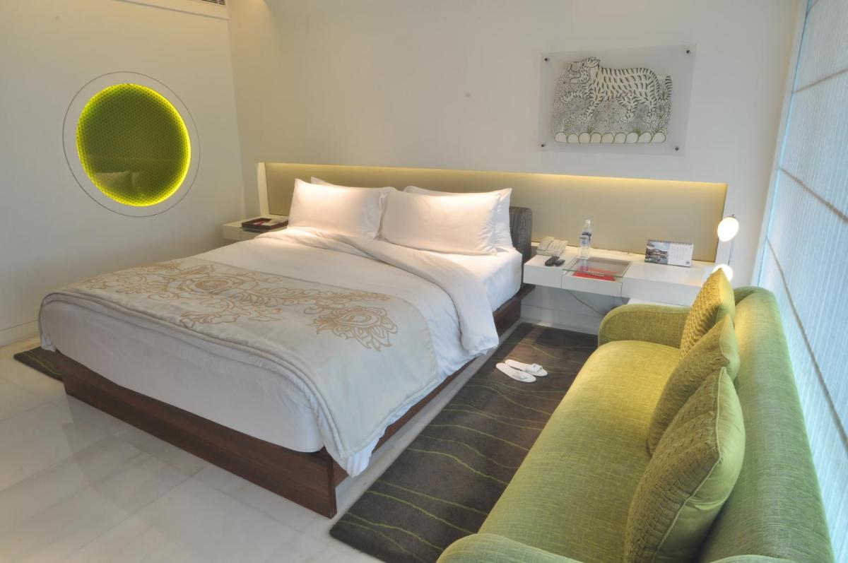 a bedroom with a large bed and a couch at The Park Hyderabad, Banjara Hills near Hussain Sagar Lake in Hyderabad a bedroom with a large bed and a couch at The Park Hyderabad, Banjara Hills near Hussain Sagar Lake in Hyderabad