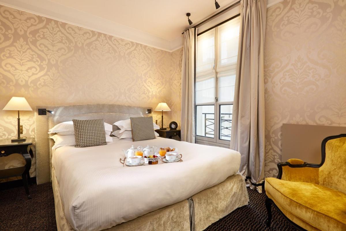 Un ou plusieurs lits dans un hébergement de l'établissement Le Pavillon de la Reine & Spa, Place des Vosges