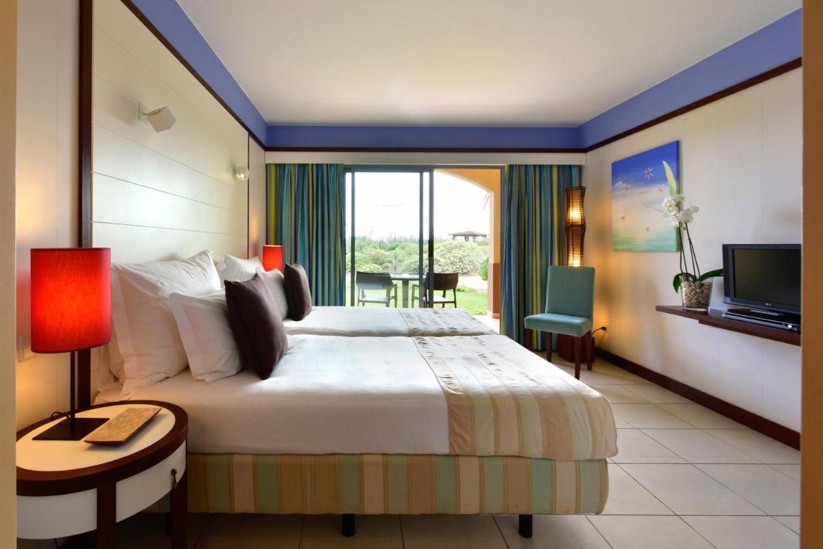Uma cama ou camas num quarto em Pestana Porto Santo Premium All Inclusive Beach & SPA Resort