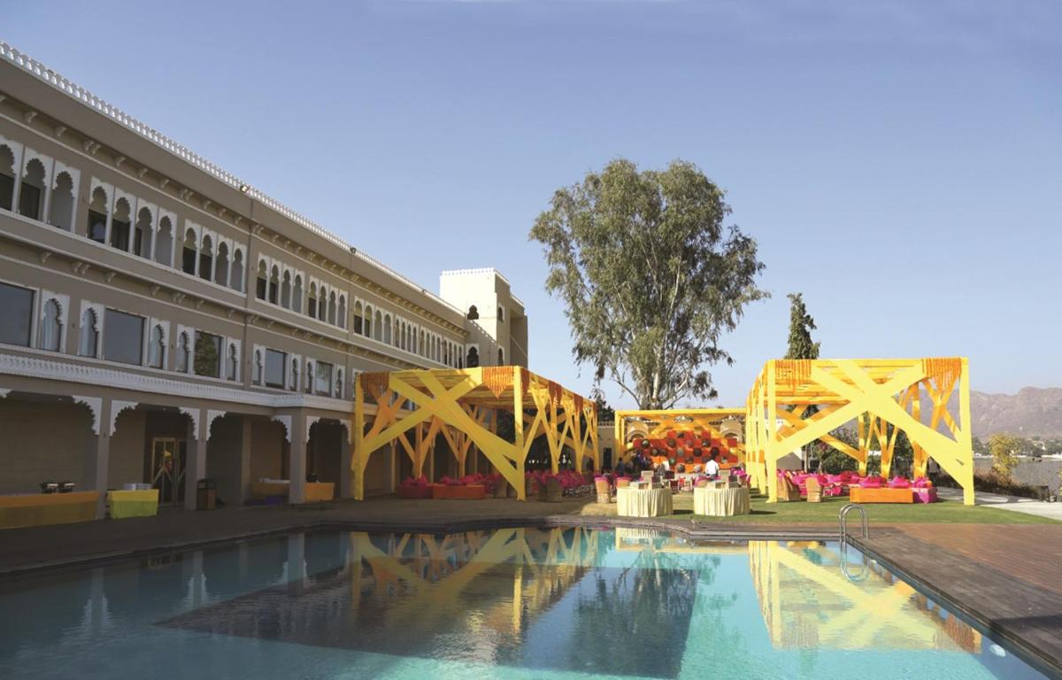 a building with a pool in front of a building at Hotel Lakend in Udaipur