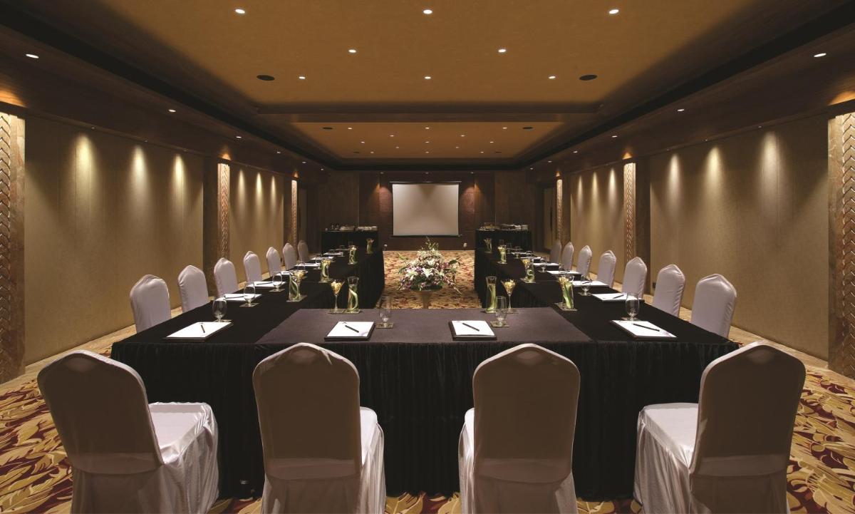 a conference room with a long table and chairs at Hotel Lakend in Udaipur