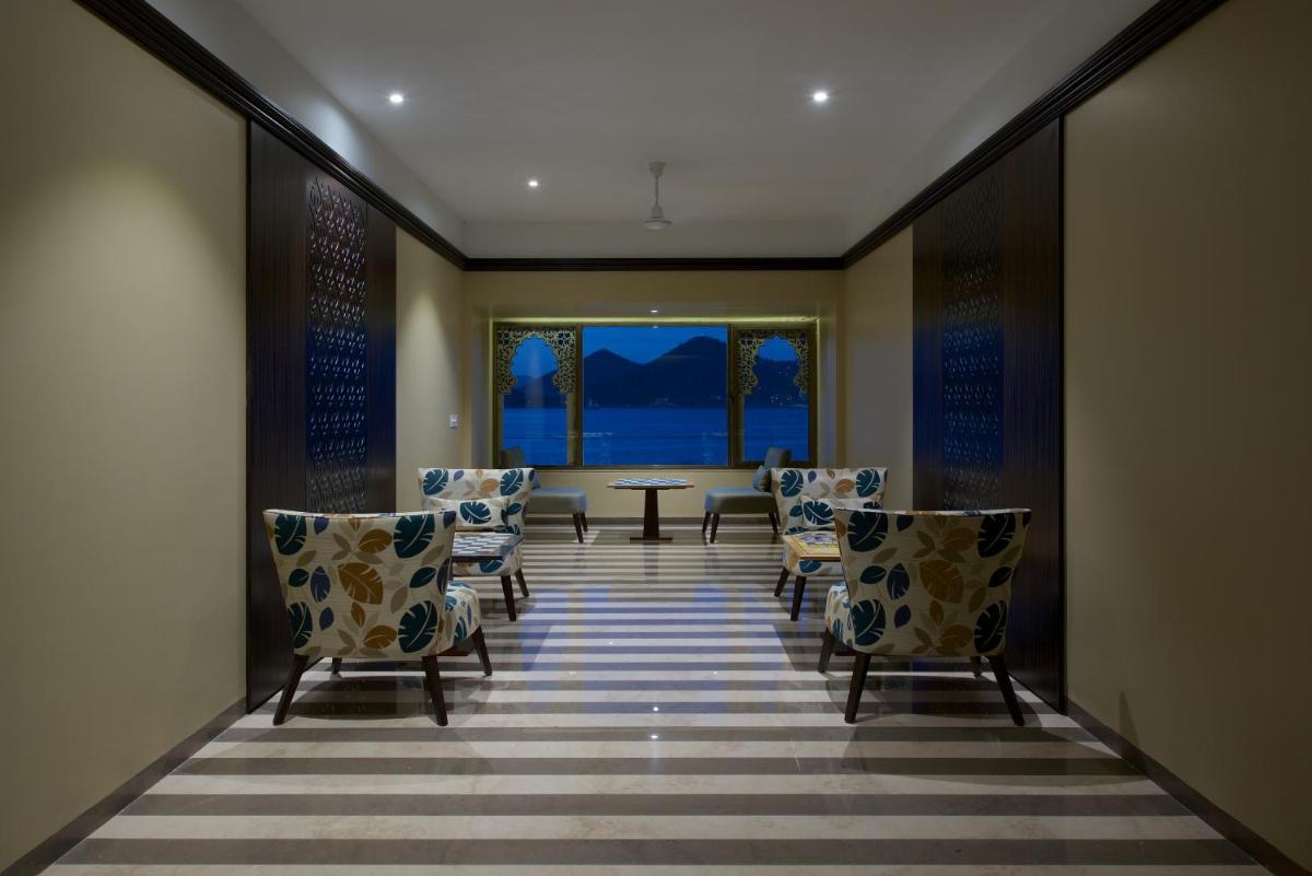 a dining room with chairs and a table and a window at Hotel Lakend in Udaipur