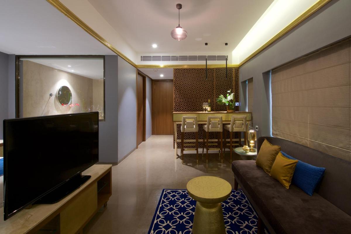 a living room with a couch and a dining room at Hotel Lakend in Udaipur