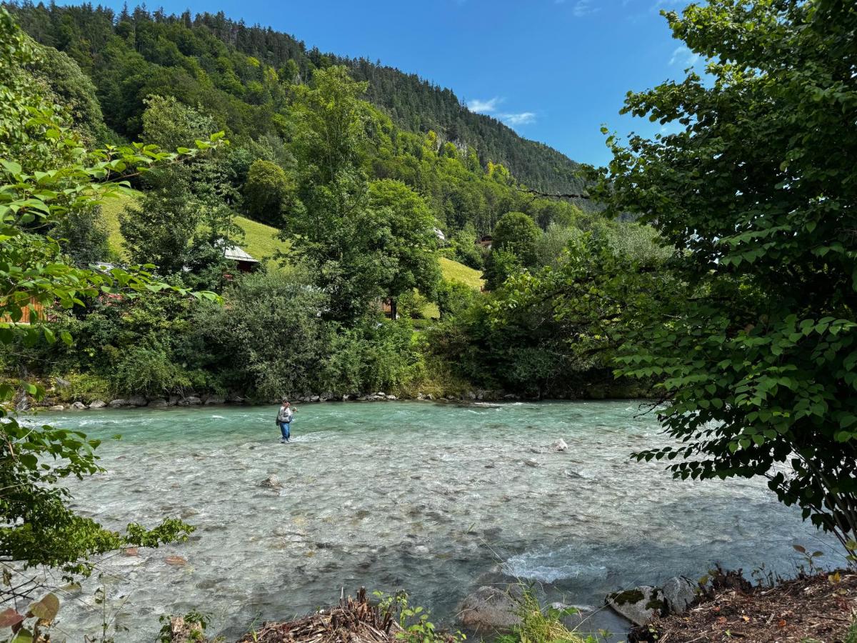eine Person, die mitten in einem Fluss steht in der Unterkunft Alpenglühn Apartments - Adult Only in Berchtesgaden + 71 Fotos