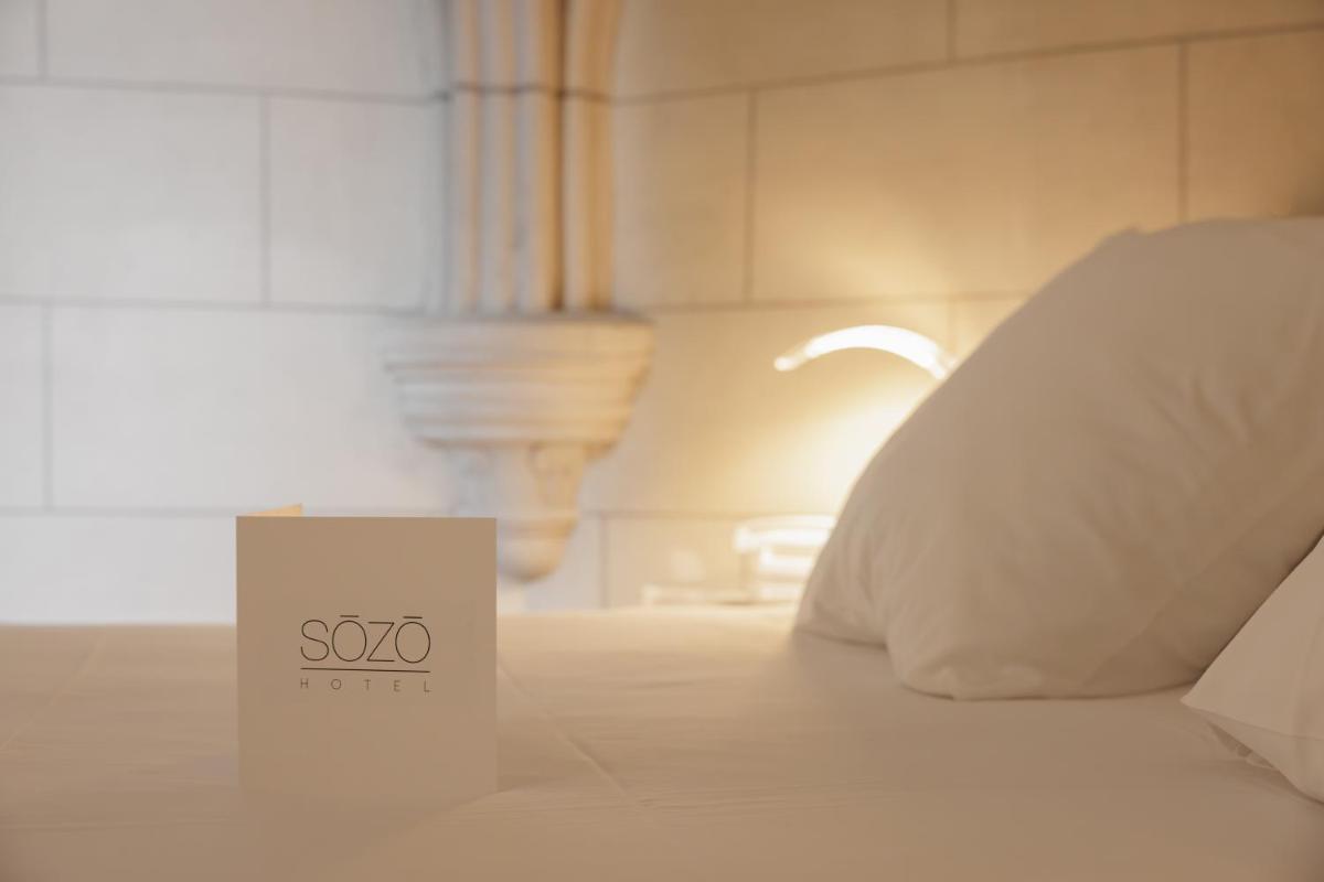 Un ou plusieurs lits dans un hébergement de l'établissement SOZO Hotel