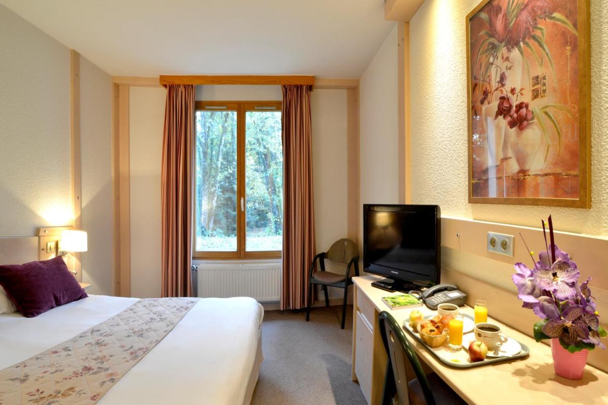 Un ou plusieurs lits dans un hébergement de l'établissement Le Bois Dormant-Hôtel Restaurant & Spa Logis Hôtel
