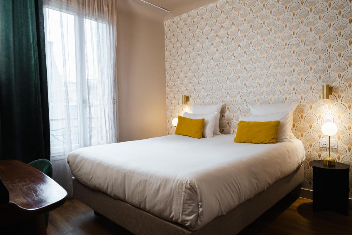 Un ou plusieurs lits dans un hébergement de l'établissement Hôtel Artemisia Montmartre
