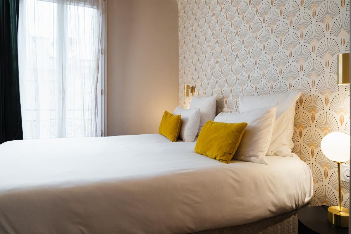 Un ou plusieurs lits dans un hébergement de l'établissement Hôtel Artemisia Montmartre