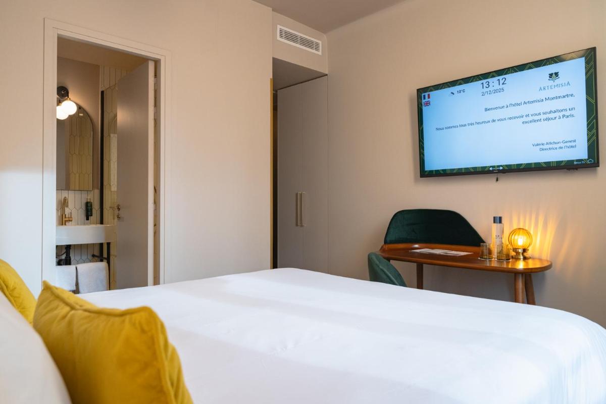 Un ou plusieurs lits dans un hébergement de l'établissement Hôtel Artemisia Montmartre