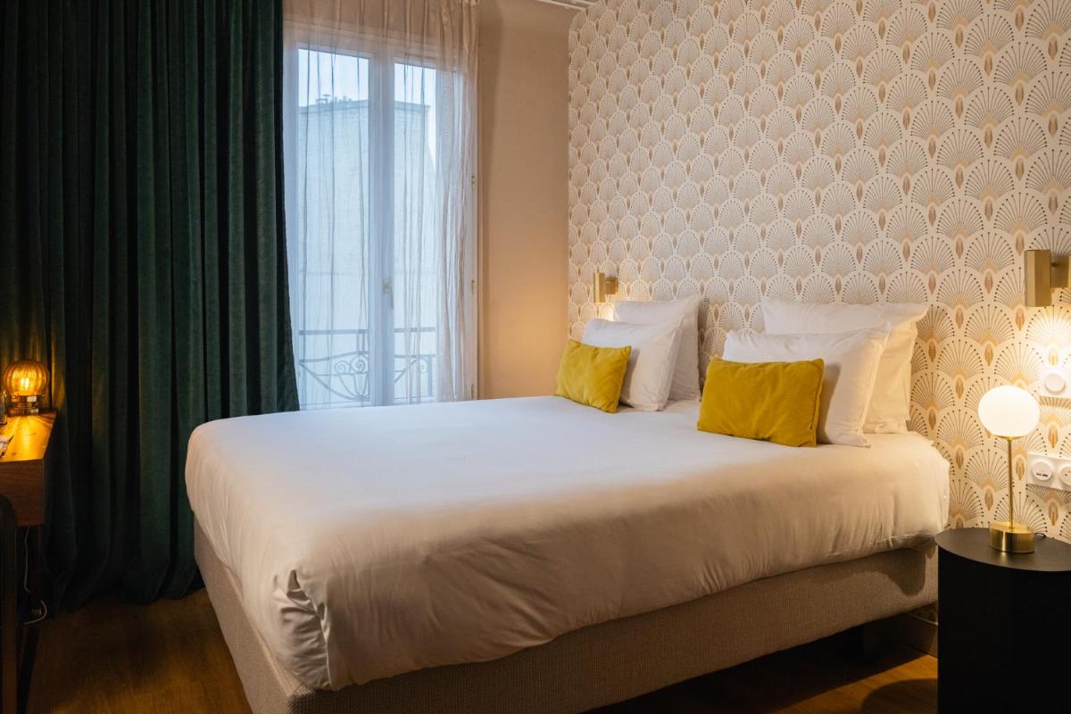 Un ou plusieurs lits dans un hébergement de l'établissement Hôtel Artemisia Montmartre