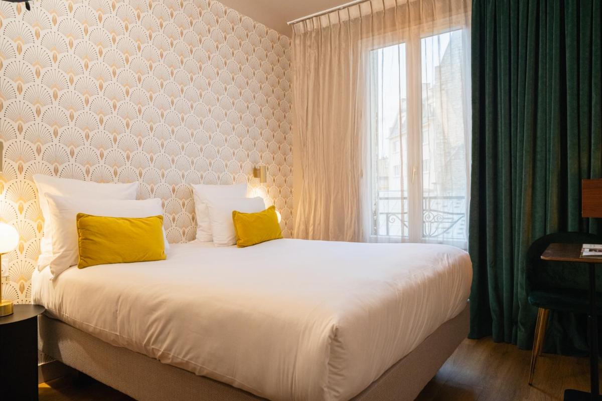 Un ou plusieurs lits dans un hébergement de l'établissement Hôtel Artemisia Montmartre