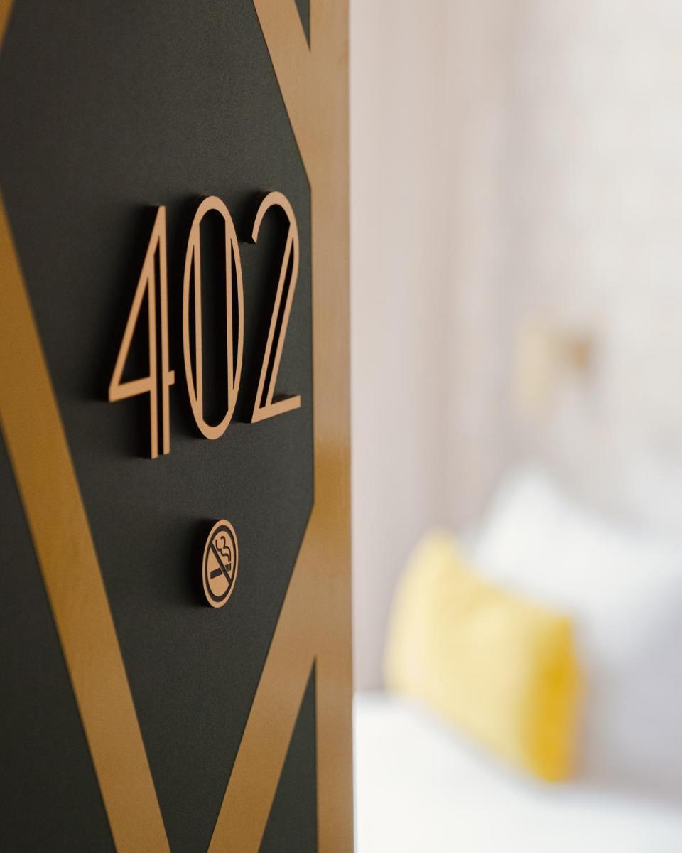 Un ou plusieurs lits dans un hébergement de l'établissement Hôtel Artemisia Montmartre