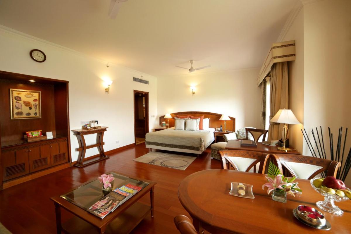 a hotel room with a bed and a table at Jaypee Palace Hotel in Agra