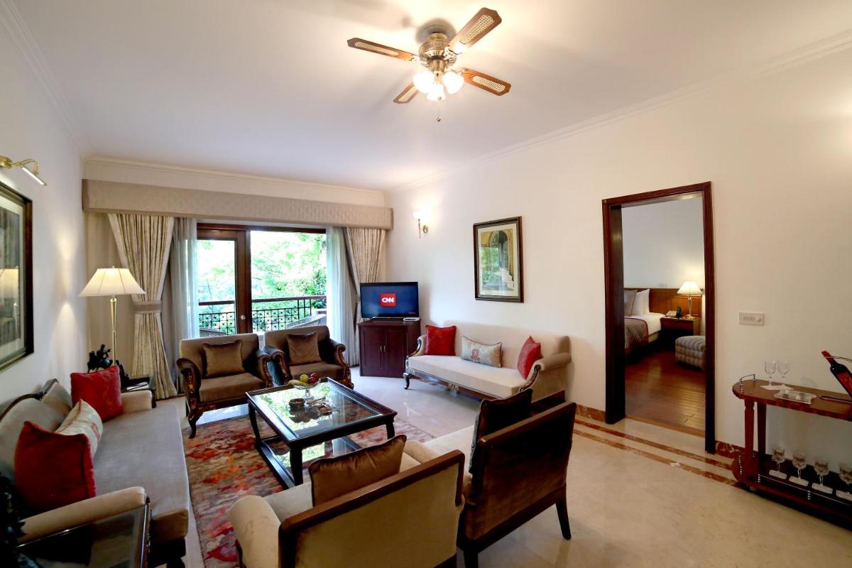 a living room filled with furniture and a ceiling fan at Jaypee Palace Hotel in Agra