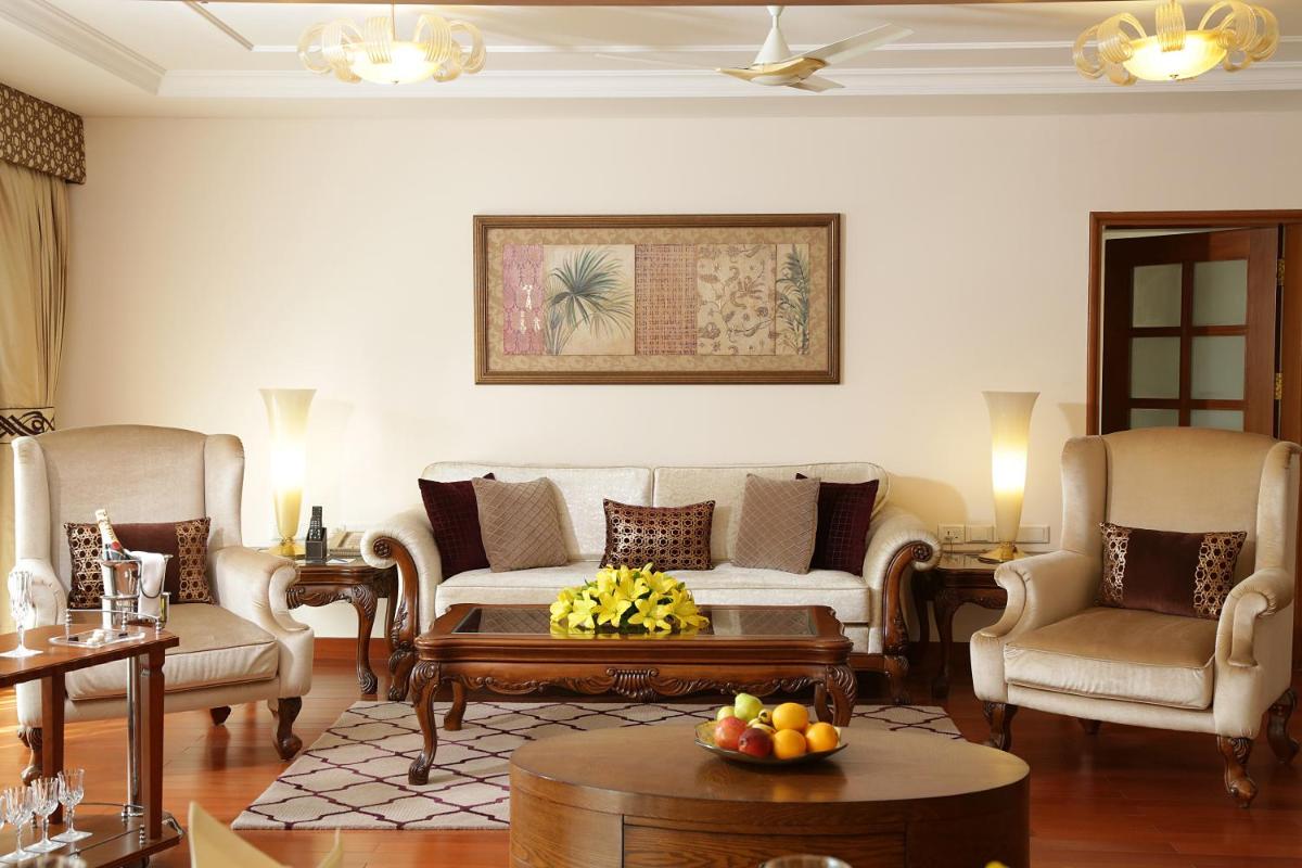 a living room with a couch and chairs and a table at Jaypee Palace Hotel in Agra