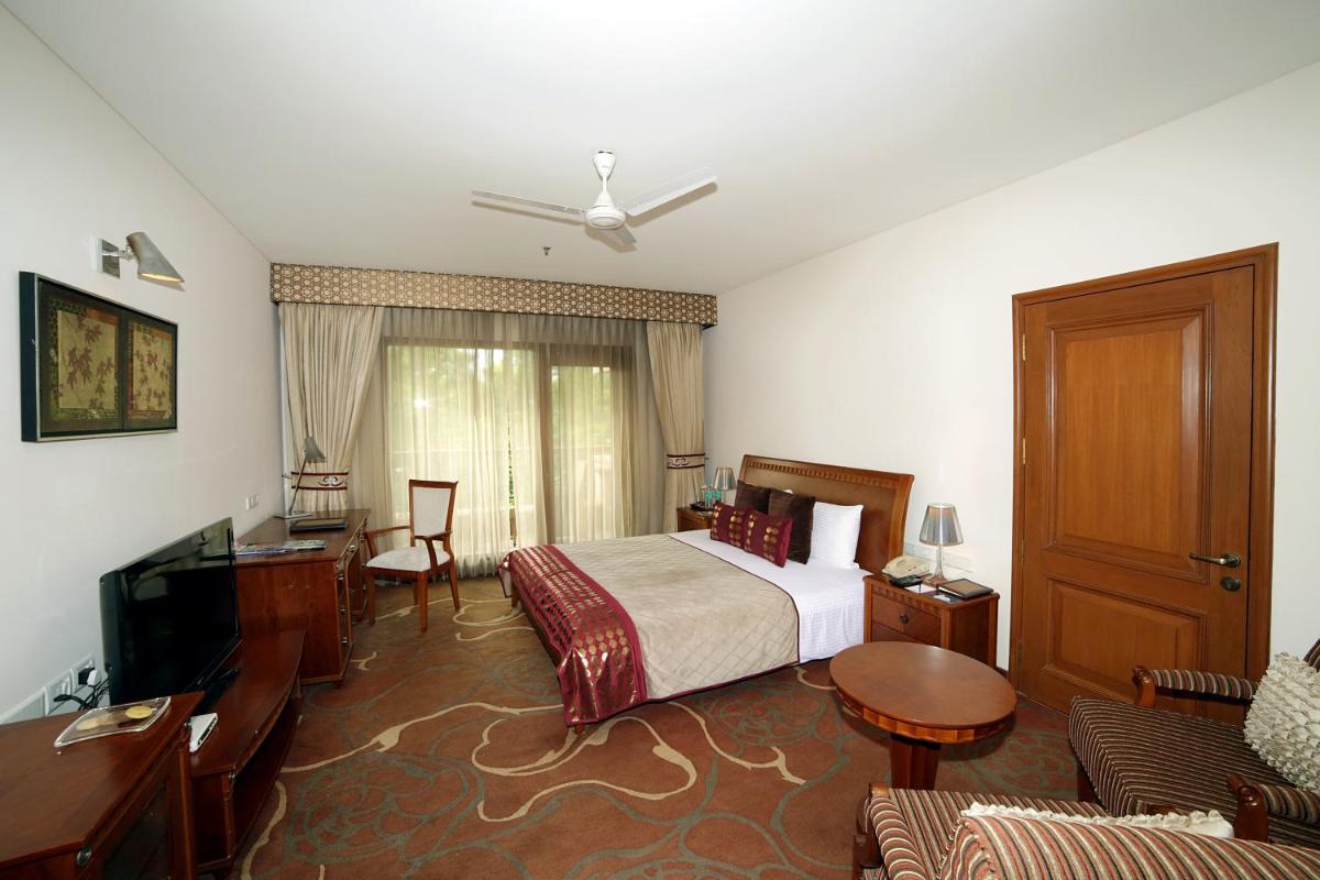 a hotel room with a bed and a television at Jaypee Palace Hotel in Agra