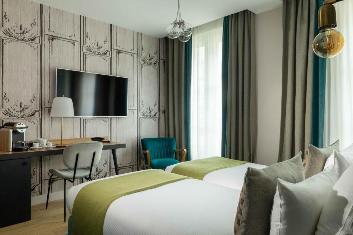 Un ou plusieurs lits dans un hébergement de l'établissement Lyric Hotel Paris Opera