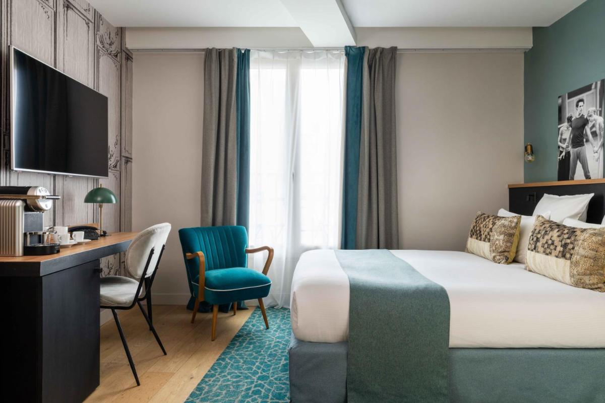 Un ou plusieurs lits dans un hébergement de l'établissement Lyric Hotel Paris Opera