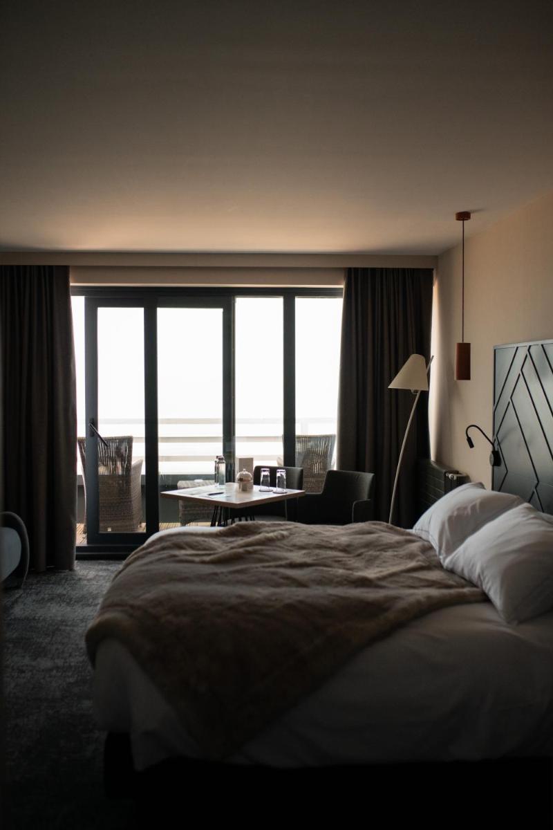 Un ou plusieurs lits dans un hébergement de l'établissement Hotel Atlantic