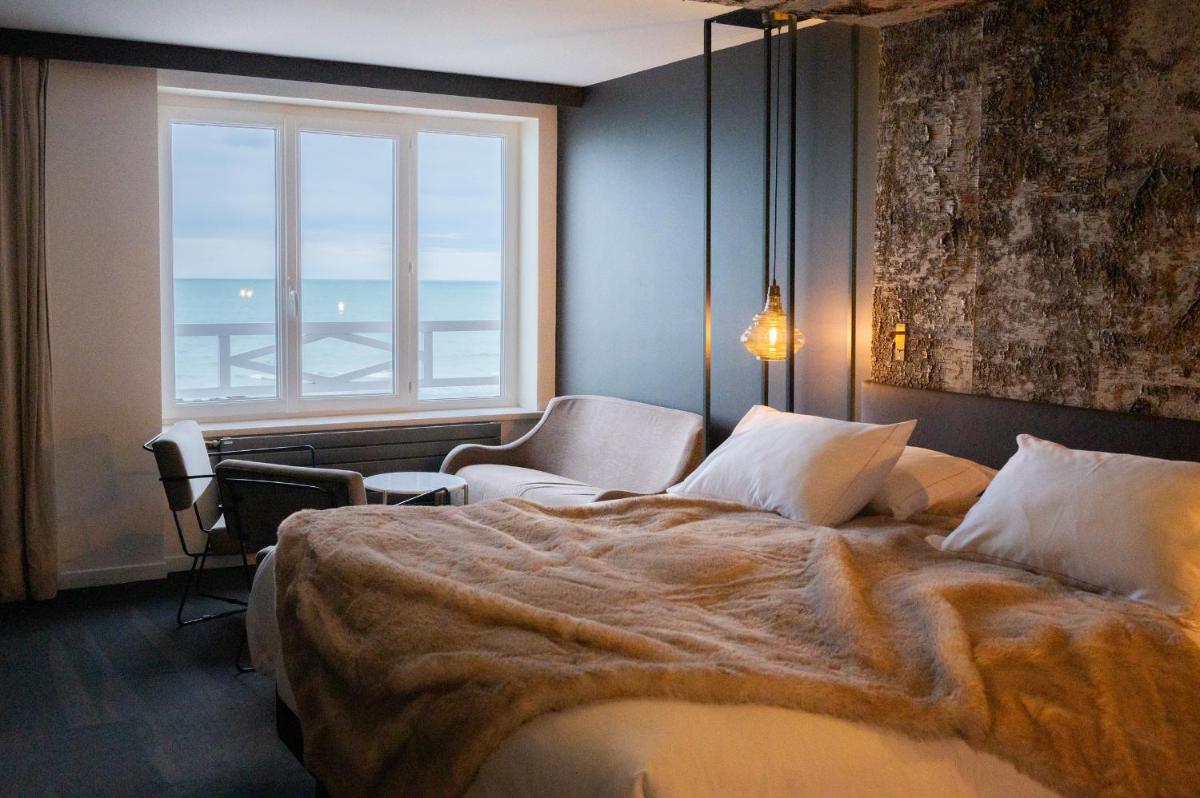 Un ou plusieurs lits dans un hébergement de l'établissement Hotel Atlantic