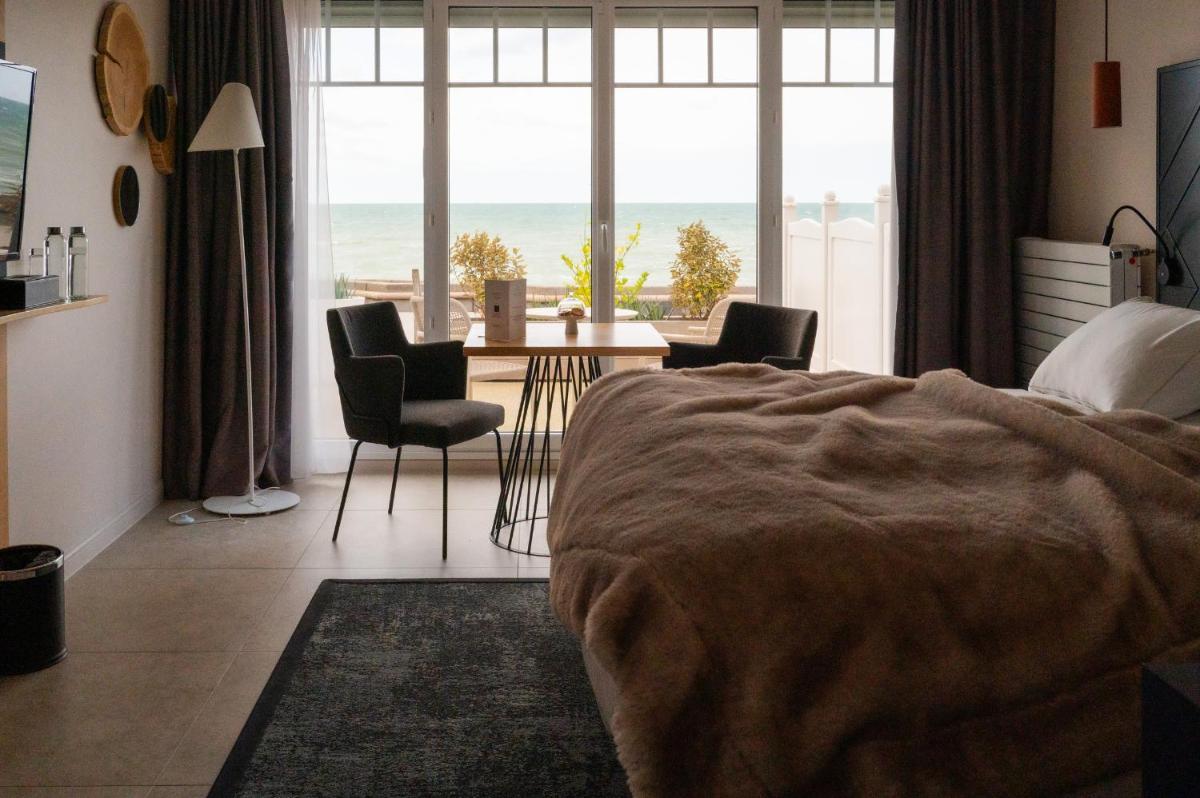 Un ou plusieurs lits dans un hébergement de l'établissement Hotel Atlantic