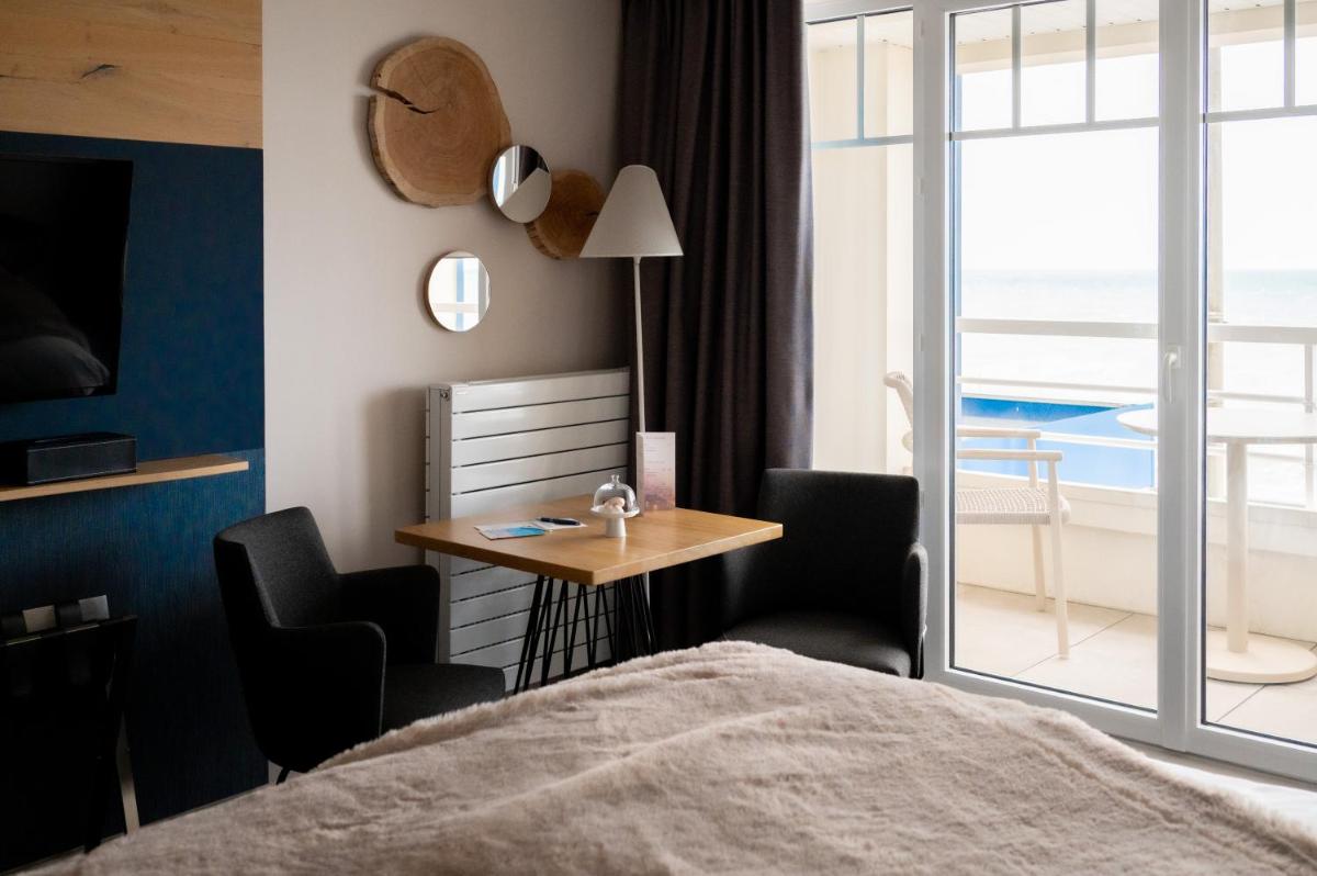 Un ou plusieurs lits dans un hébergement de l'établissement Hotel Atlantic