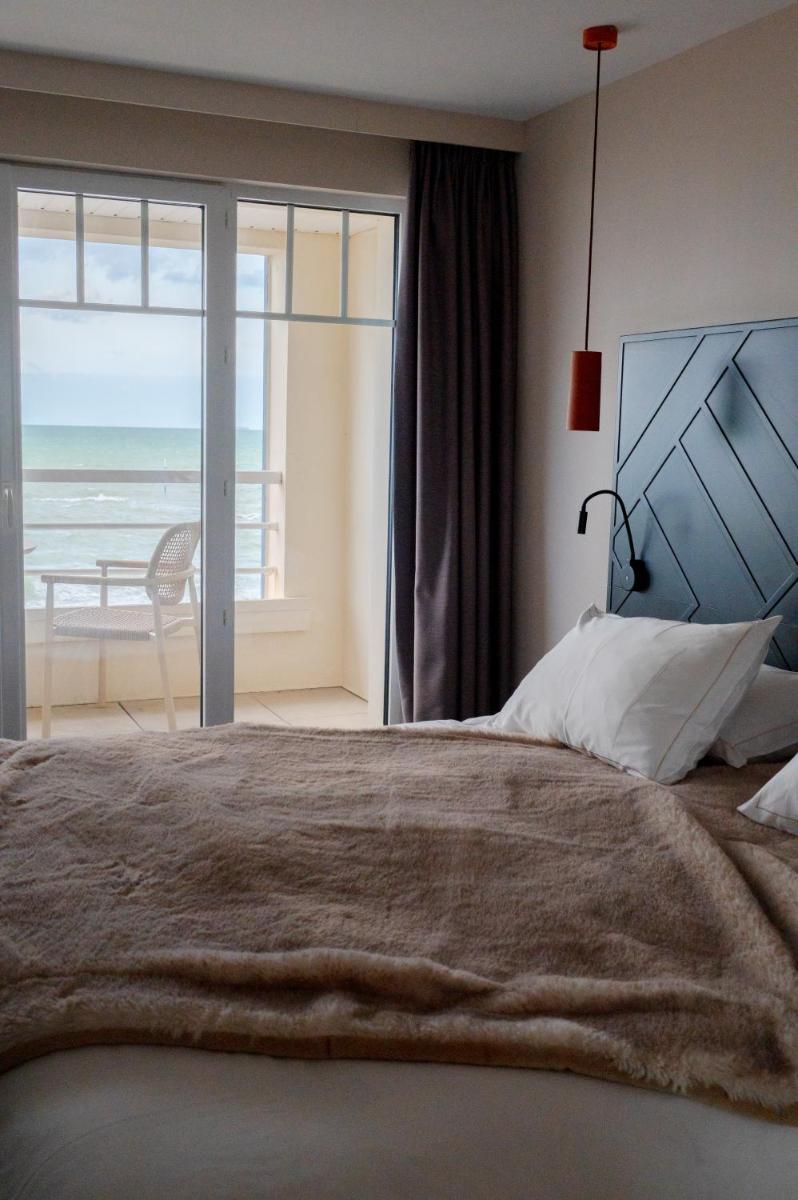 Un ou plusieurs lits dans un hébergement de l'établissement Hotel Atlantic