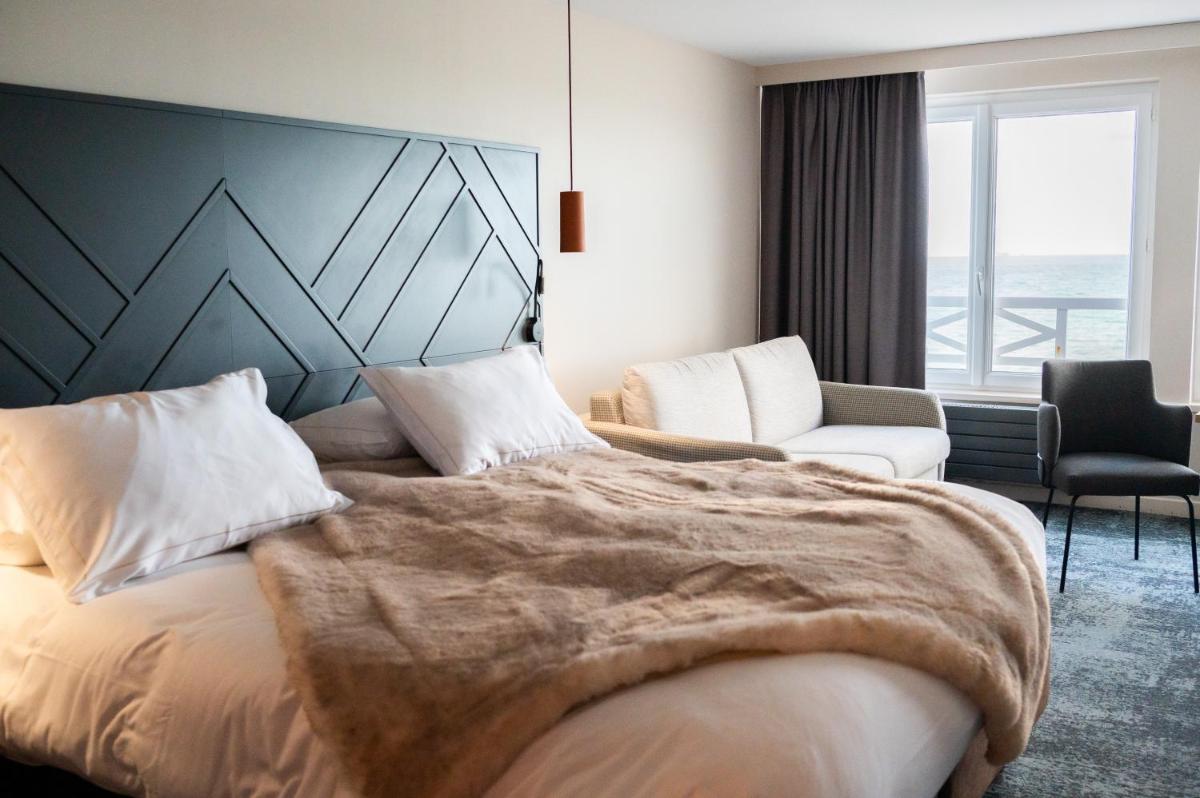 Un ou plusieurs lits dans un hébergement de l'établissement Hotel Atlantic