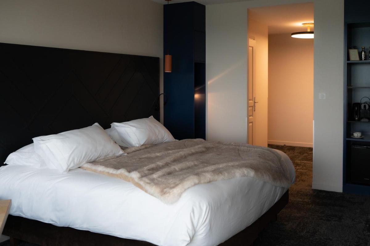 Un ou plusieurs lits dans un hébergement de l'établissement Hotel Atlantic