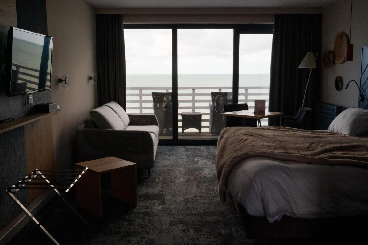 Un ou plusieurs lits dans un hébergement de l'établissement Hotel Atlantic