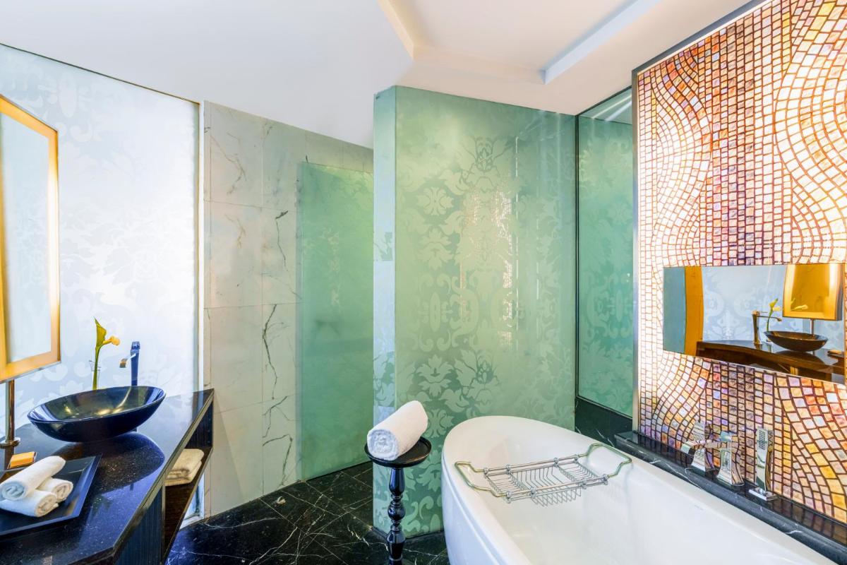 a bathroom with a tub and a sink at Sofitel Mumbai BKC in Mumbai