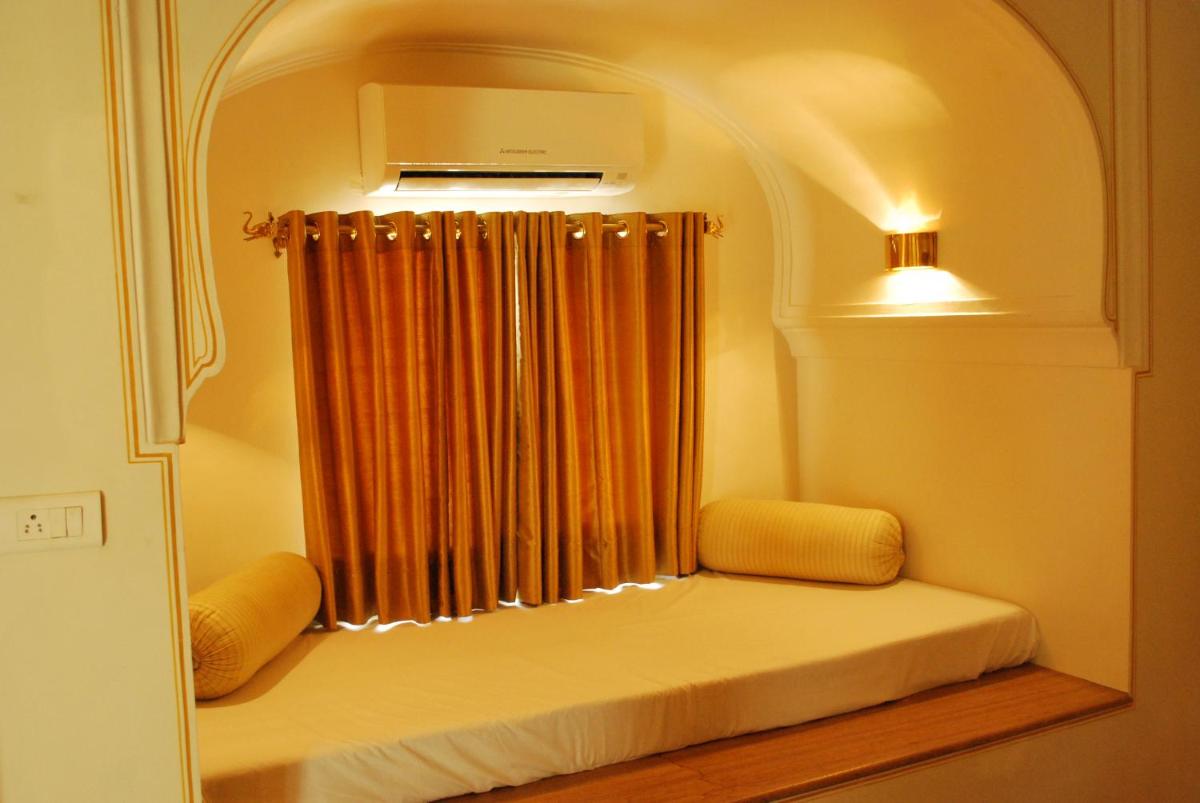 a room with a window with a curtain at Royal Heritage Haveli - By Leisure Hotels in Jaipur