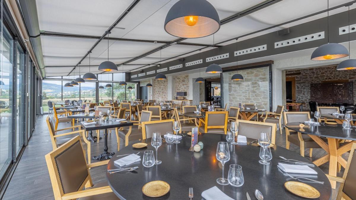 un restaurant avec des tables et des chaises dans une salle dans l'établissement Domaine De Saint Clair, à Saint-Clair