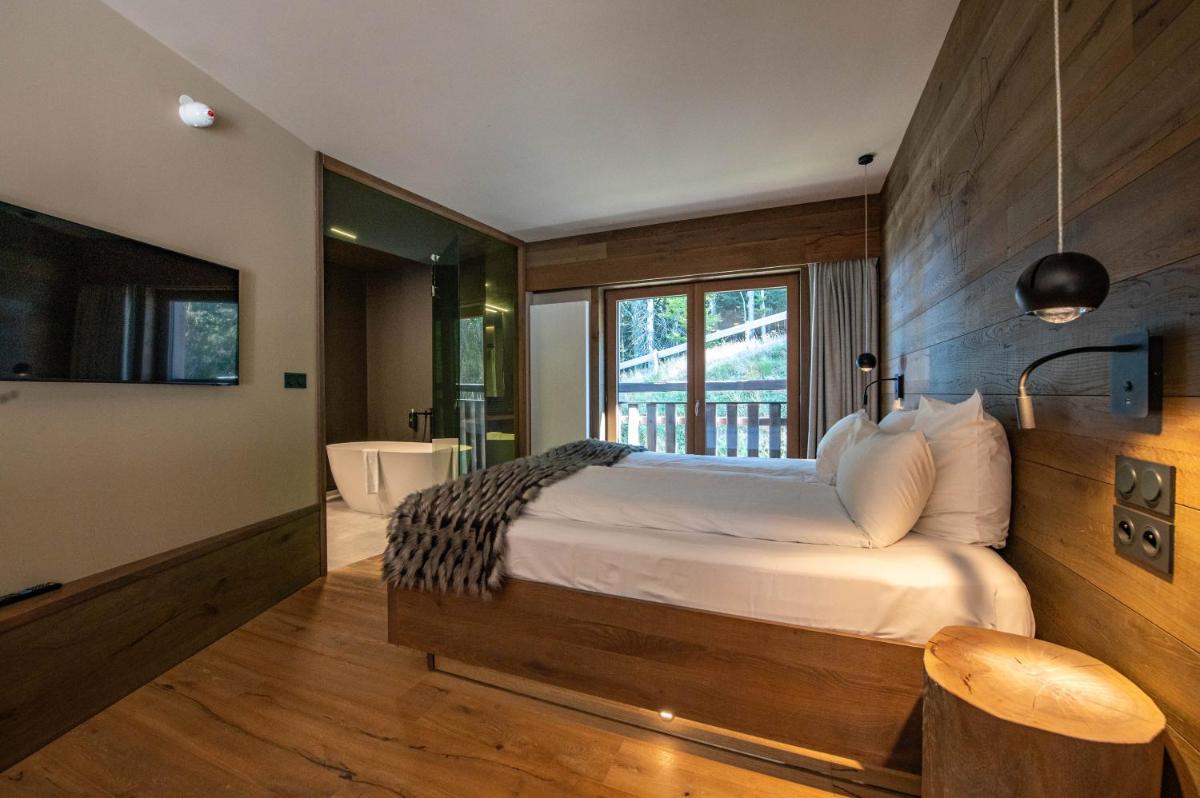 Un ou plusieurs lits dans un hébergement de l'établissement Chalet Hôtel & Spa Le Collet