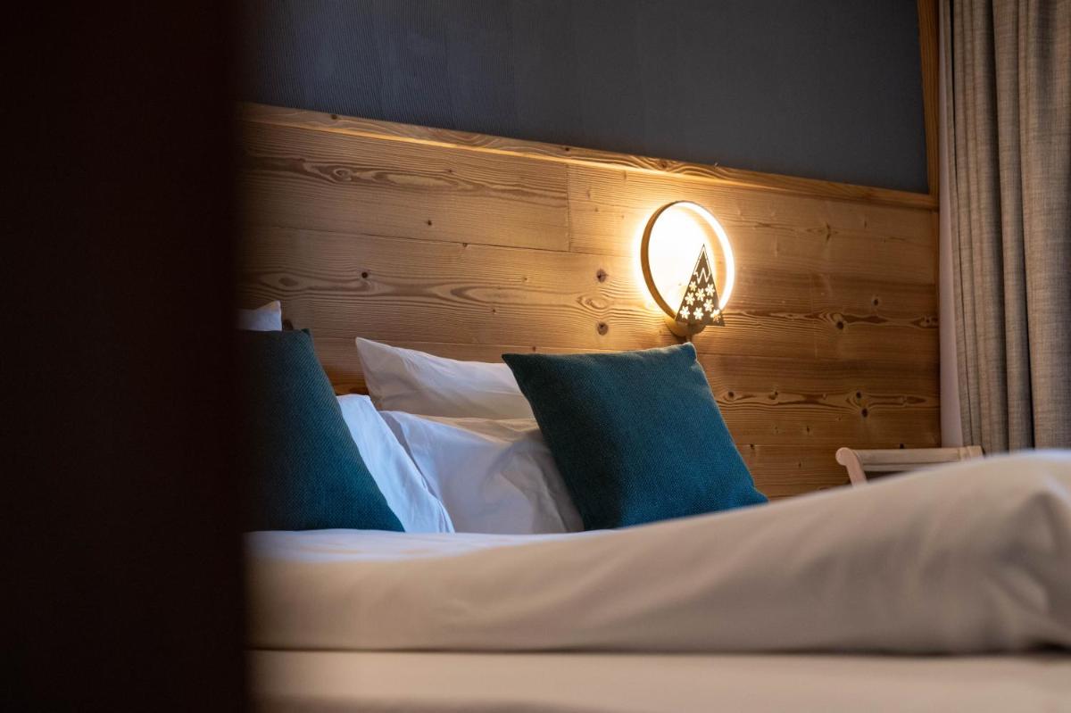 Un ou plusieurs lits dans un hébergement de l'établissement Chalet Hôtel & Spa Le Collet